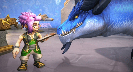 A gnome looks over a ledger with spectacles on, while her dragonriding companion leans in, in World of Warcraft: Dragonflight.