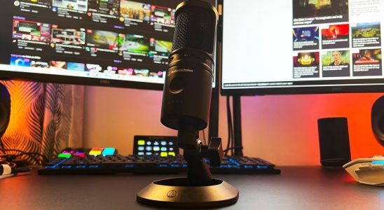 Audio-Technica AT2020USB-XP on a gaming desk in front of a streaming controller and monitors