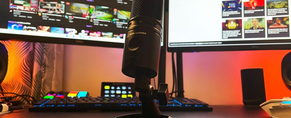 Audio-Technica AT2020USB-XP on a gaming desk in front of a streaming controller and monitors