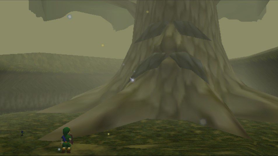 Un enfant Link se tient devant le Grand Arbre Mojo, un arbre géant au visage triste, dans Zelda : Ocarina of Time