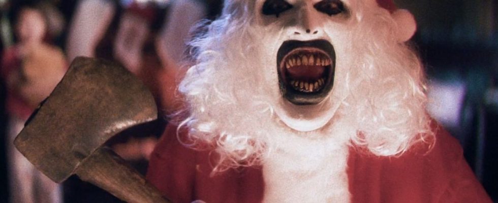 David Howard Thorton as Art the Clown, laughing while dressed as Santa with an axe, in Terrifier 3.