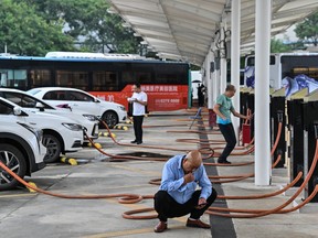 Les conducteurs attendent que leurs véhicules électriques soient rechargés à la station de recharge d'Antuoshan à Shenzhen, dans la province chinoise du Guangdong (sud).