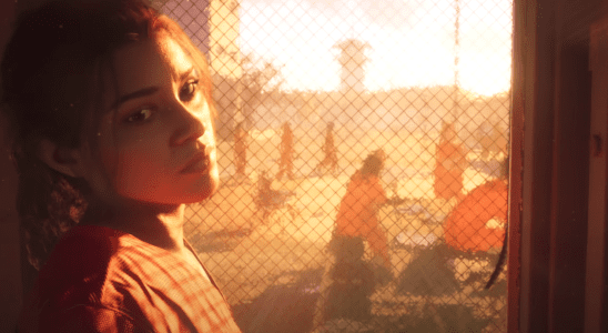 Lucia, a protagonist from Grand Theft Auto 6, looks over her shoulder at the camera while backlit by a prison yard.