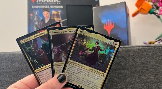 Three cards from Magic: The Gathering Doctor Who being held up in front of the Commander Deck box