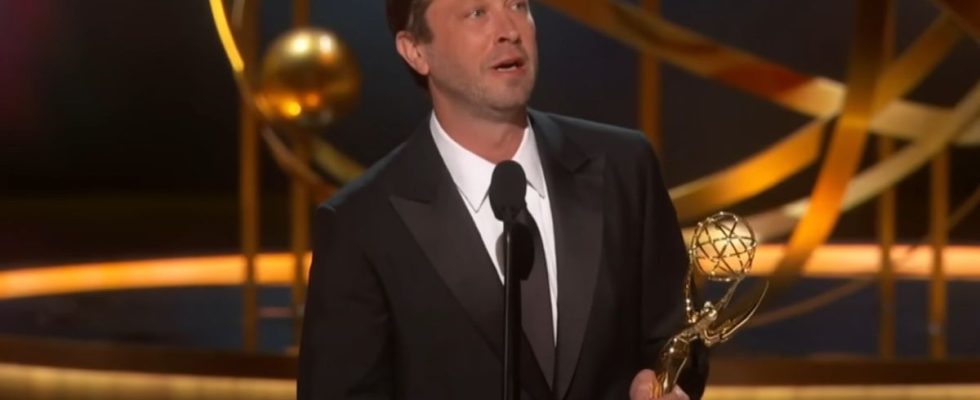 A screenshot of Ebon Moss-Bacrach holding his Emmy giving a speech at the 75th Emmy Awards.