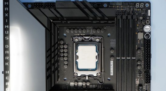 Intel Core i9 14900K CPU on a box and inside a motherboard socket.