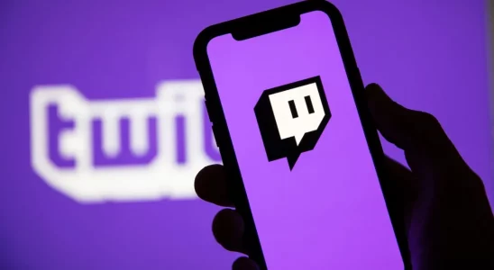 Twitch logo on a phone screen with a bright, purple background.