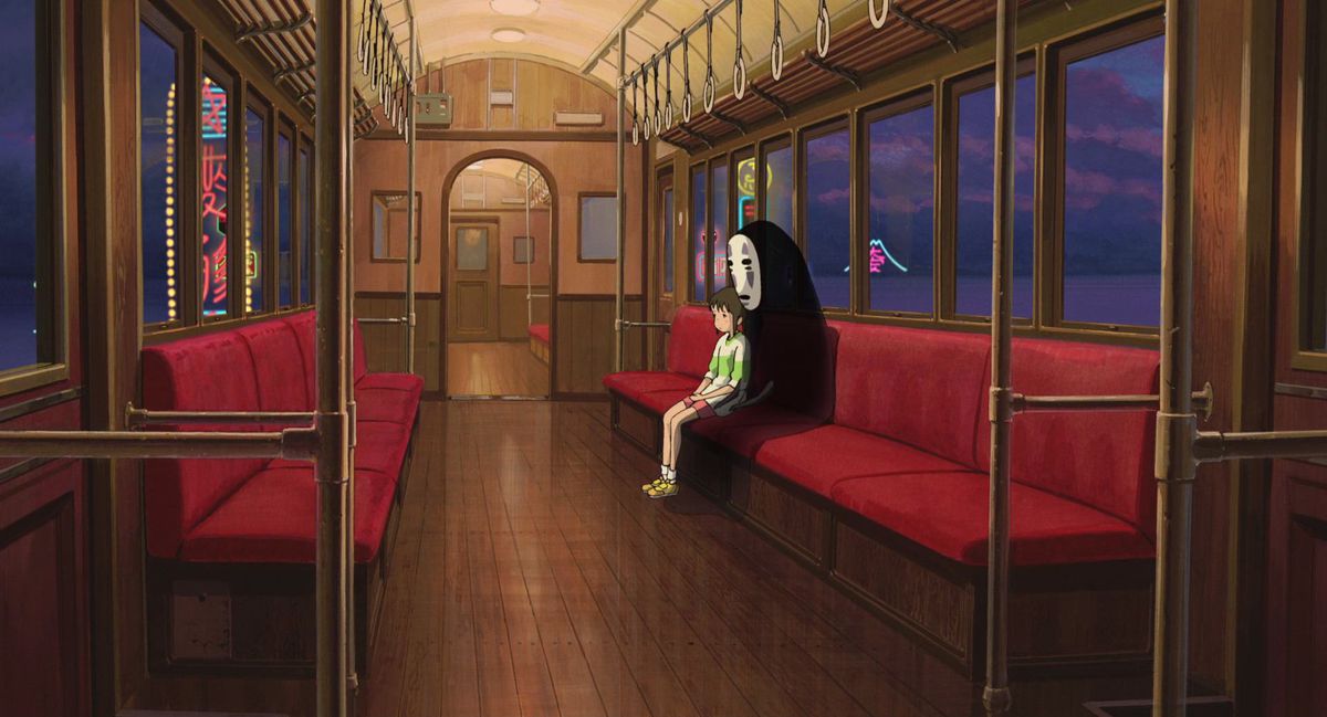 égarés : Chihiro et No-Face sont assis dans un train la nuit