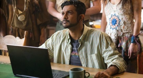 Utkarsh Ambudkar as Jay sitting at a computer looking up in Ghosts.