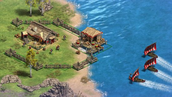 Age of Empires 2 : Definitive Edition DLC Victors and Vanquished - Des bateaux vikings s'approchent d'un petit village au bord de l'eau dans ce jeu de stratégie classique.