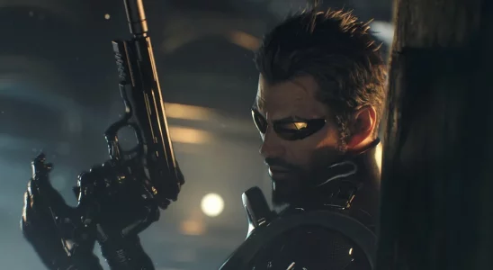 Deus Ex: Adam Jensen loading a pistol while leaning against a wall.