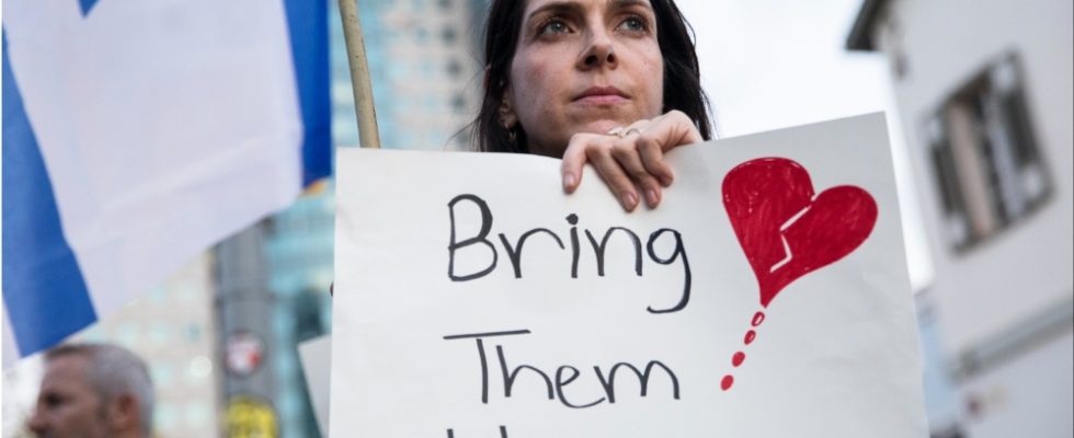 A woman holds a sign during a protest calling to bring back the hostages that were kidnaped last Saturday during Hamas' and Palestinan terrorists attack