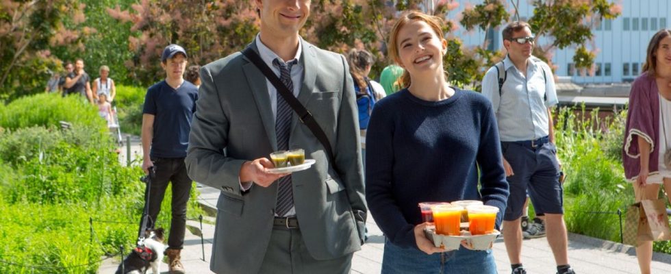Glen Powell and Zoey Deutch standing next to each other and holding drinks in a press image for Set It Up.