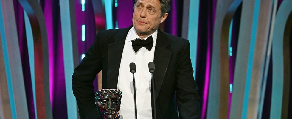 LONDON, ENGLAND - FEBRUARY 18: Hugh Grant presents the Director Award on stage during the EE BAFTA Film Awards 2024 at The Royal Festival Hall on February 18, 2024 in London, England. (Photo by Kate Green/BAFTA/Getty Images for BAFTA)