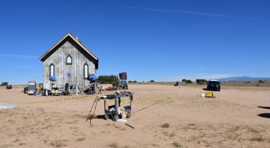 A church building and a metal cart, with police tape, on a ranch in New Mexico.