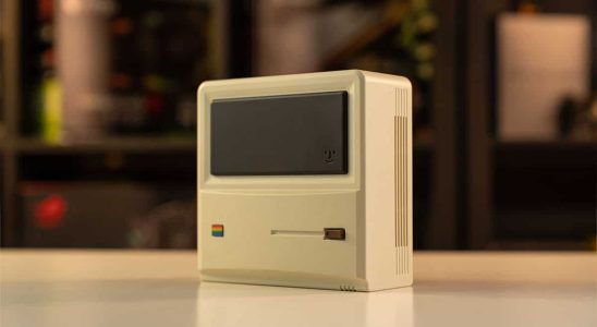 An apple computer sitting on a table.