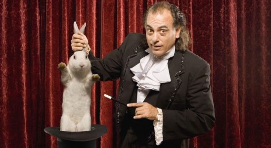 A magician holding a rabbit.