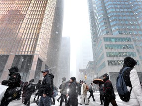 Piétons dans le quartier financier de Toronto par une journée enneigée.