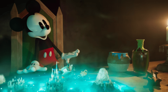 Mickey Mouse looks at a kingdom on a table.