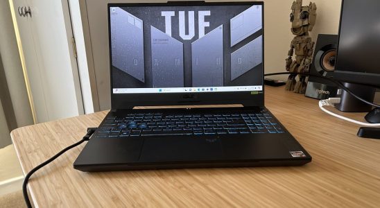 Asus TUF A15 gaming laptop open on a wooden desk