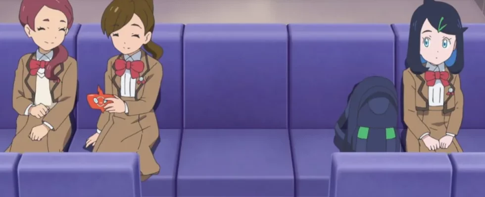 Liko from Pokemon Horizons the Series sitting on a bus next to two classmates, all in school uniform