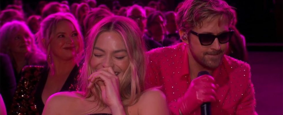 Margot Robbie laughing while Ryan Gosling performs "I