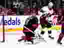 Le gardien des Hurricanes de la Caroline Frederik Andersen (31 ans) fait un arrêt alors que l'ailier droit des Sénateurs d'Ottawa Mathieu Joseph (21 ans) joue devant, lors de la deuxième période d'un match de hockey de la LNH à Ottawa, le dimanche 17 mars 2024.