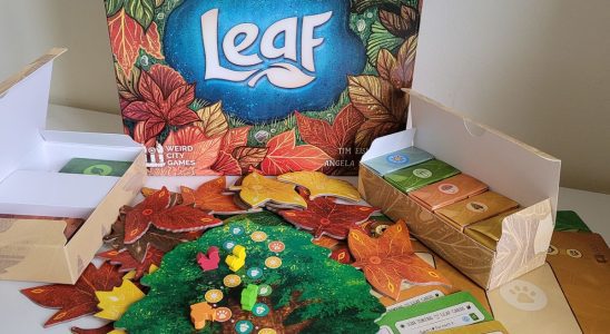 Leaf box and board game components on a white surface