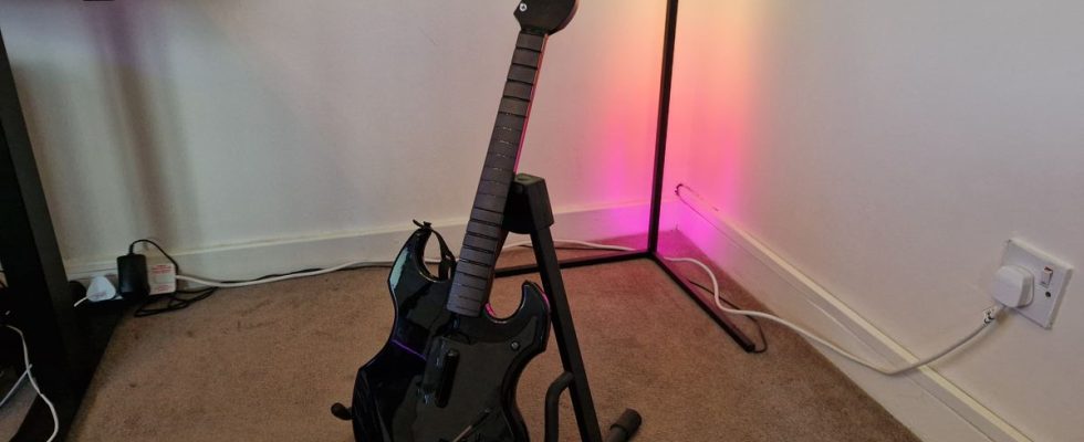 PDP Riffmaster preview image of the guitar on a stand in front of an RGB corner lamp