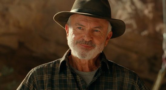 Sam Neill smirking in the middle of a Utah dig site in Jurassic World Dominion.
