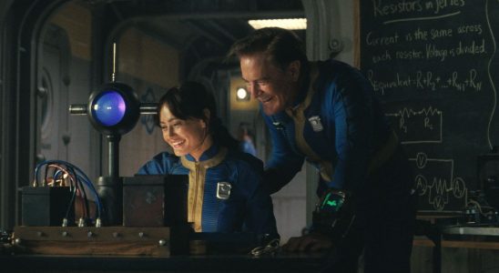 Ella Purnell and Kyle MacLachlan share a laugh around a scientific device in Fallout.