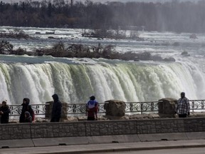 Les visiteurs admirent la vue sur les chutes du Niagara du côté canadien, le 24 mars 2023.