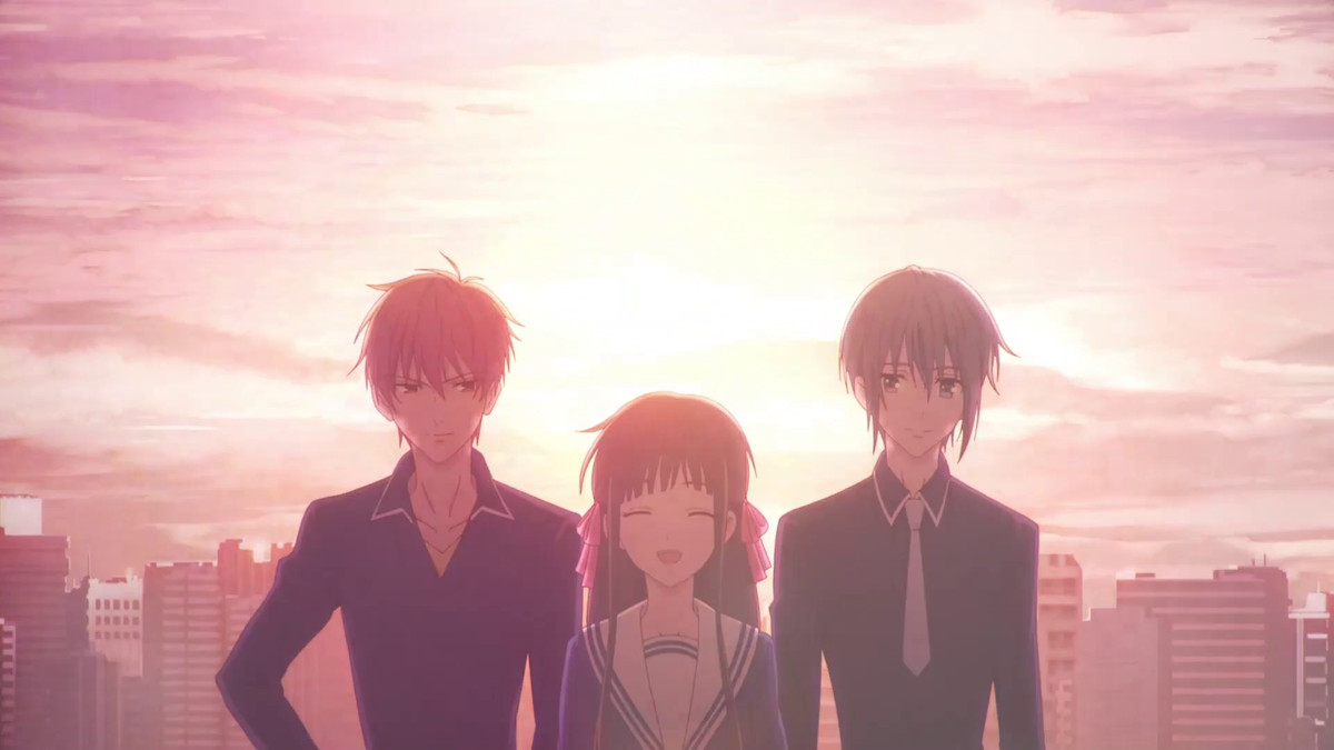 Tohru debout avec Yuki et Kyo contre un soleil couchant dans Fruits Basket