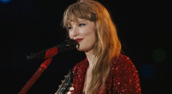 A screenshot of Taylor Swift smiling while singing All Too Well during the Eras Tour.