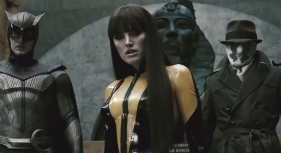 Patrick Wilson, Malin Åkerman, and Jackie Earle Haley cautiously walking down stairs in Watchmen.